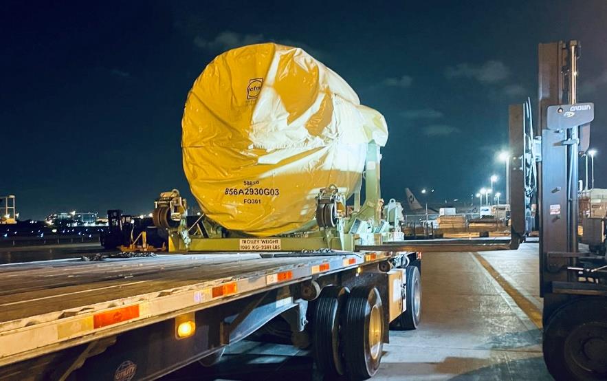 AOG aircraft material loaded on flatbed at night